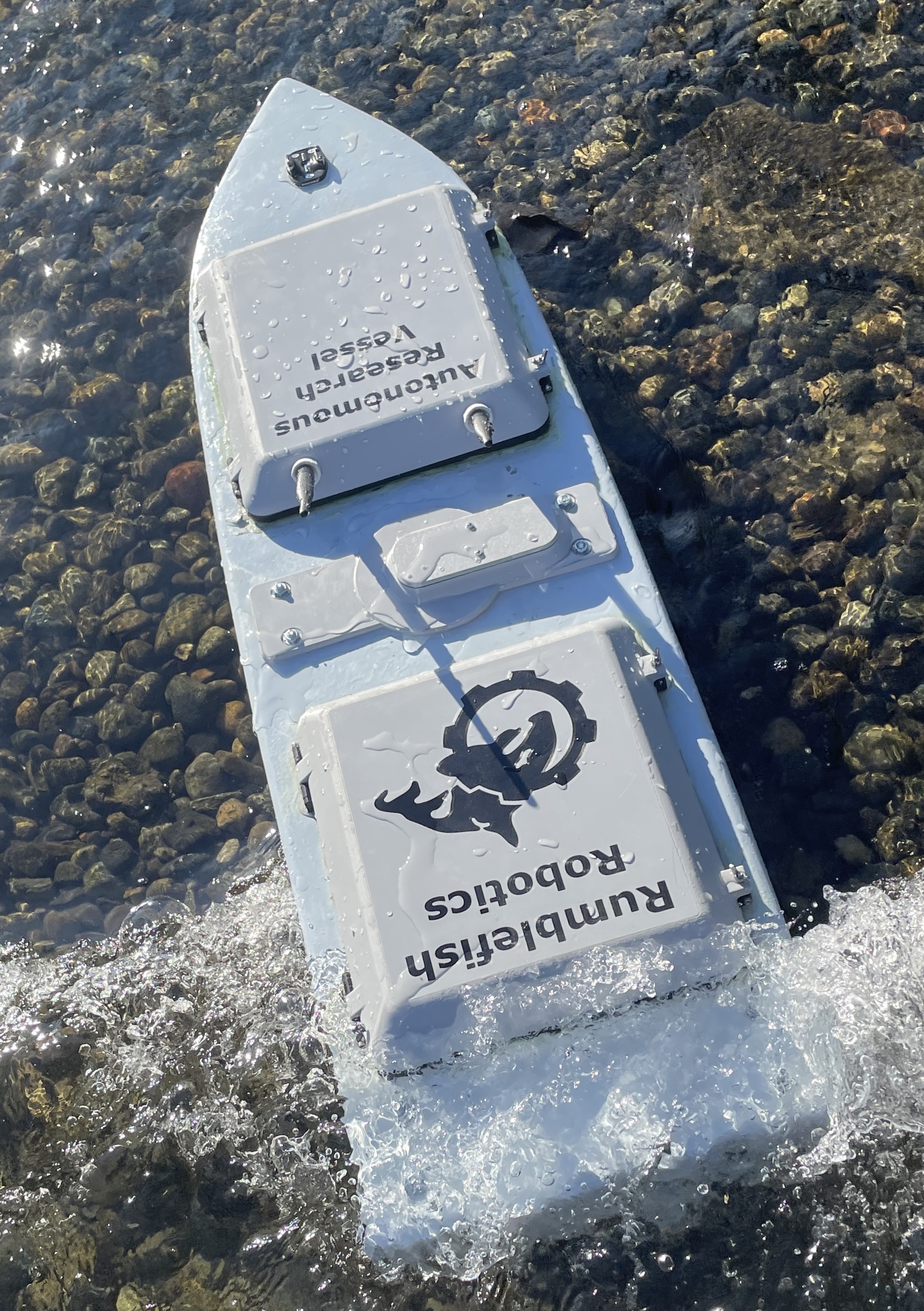 Rumblefish USV beached on a rocky shore demonstrating littoral grounding defense